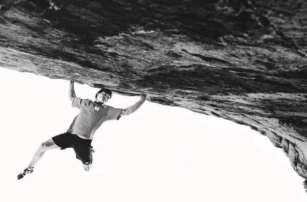 Climber Nathaniel Coleman climbing boulder