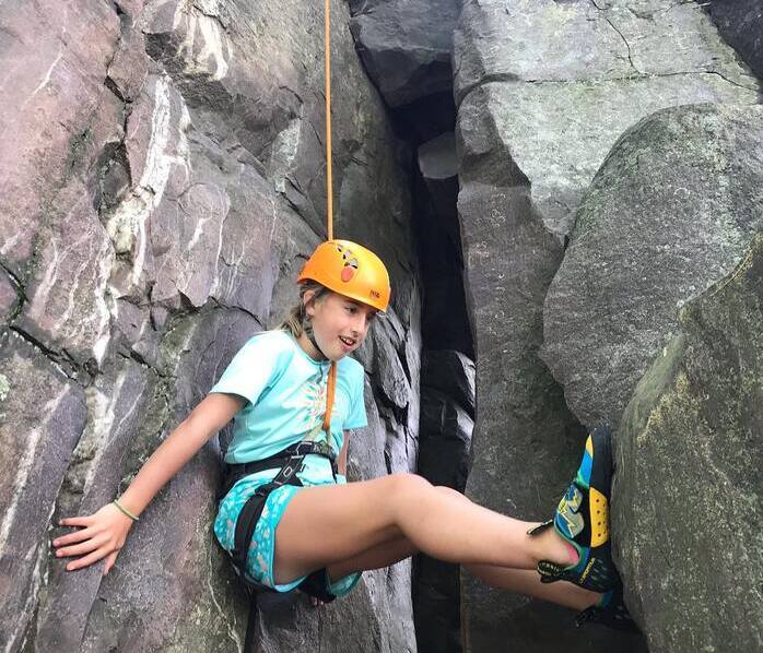 girl climber stemming on rock