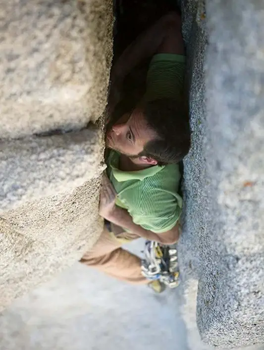 climber stemming in chimney rock climbing