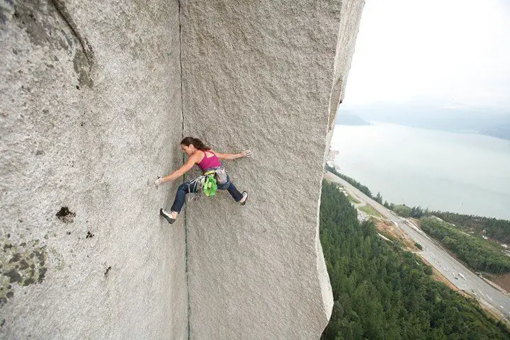 Climber stemming with legs on dihedral