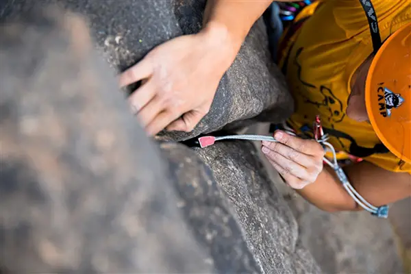 male climber placing nut