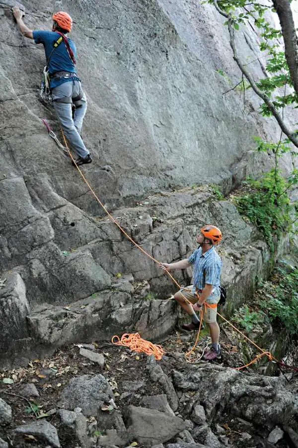 belayer on ground while climber is on wall