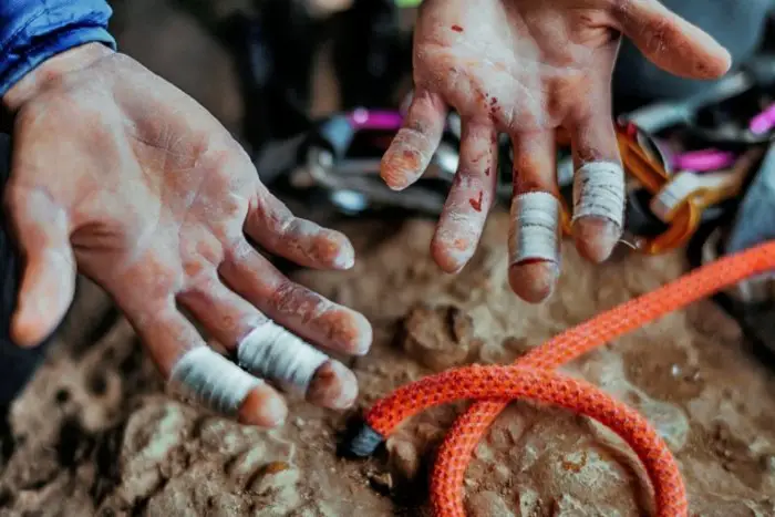 Climber with taped fingers