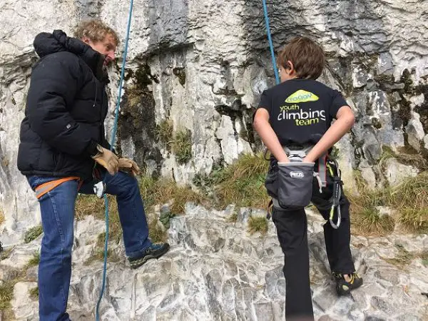 Young Toby Roberts at the crag about to climb Raindogs