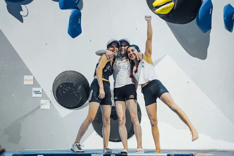 Oriane Berton on the podium with Janja Garnbret and Brooke Raboutou climbers