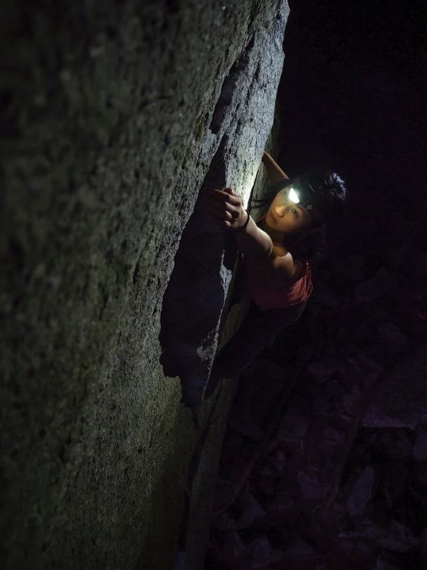 tasha chang rock climbing in the dark with headlamp